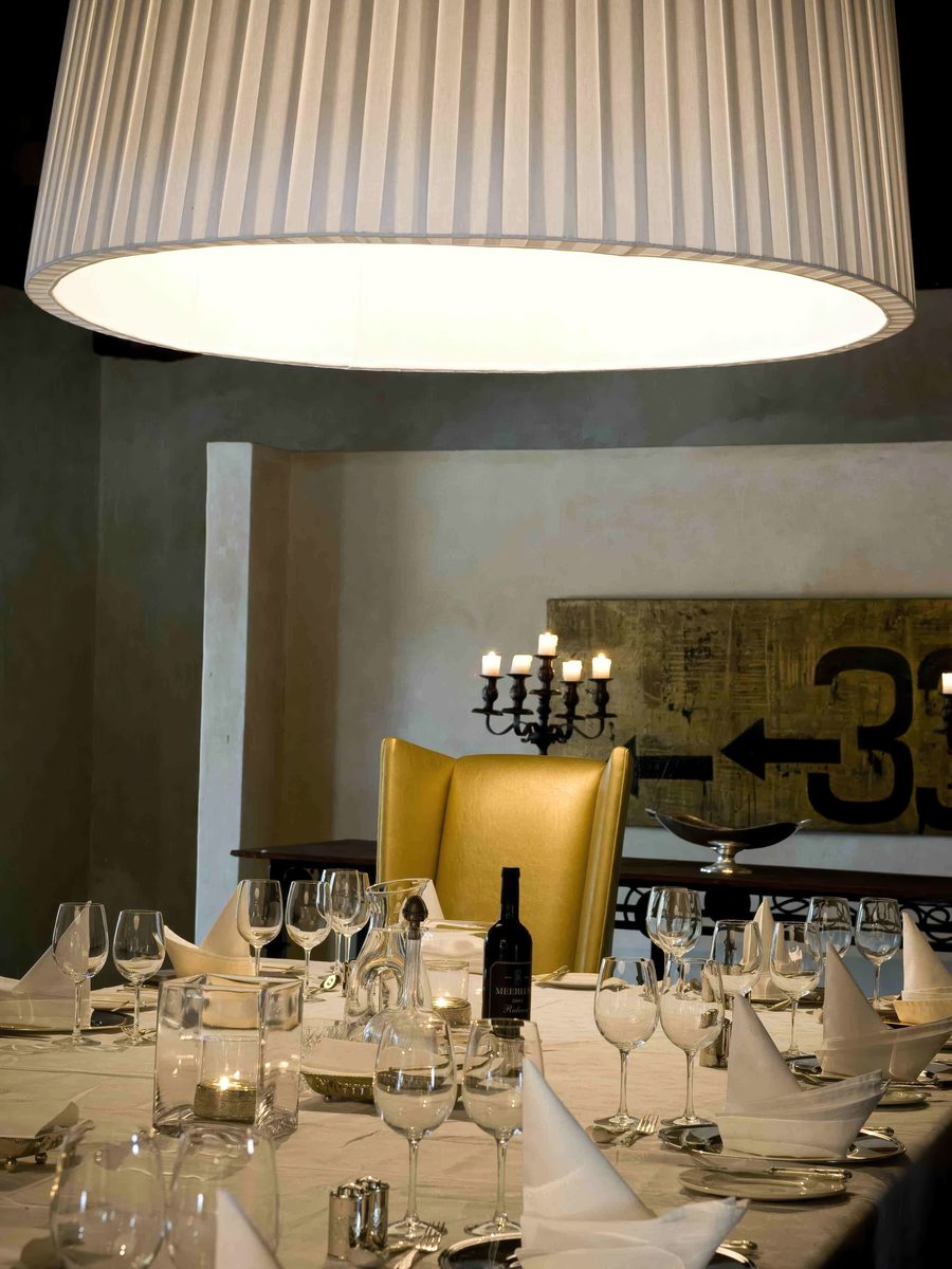 Large pleated drum pendant over a private dining table