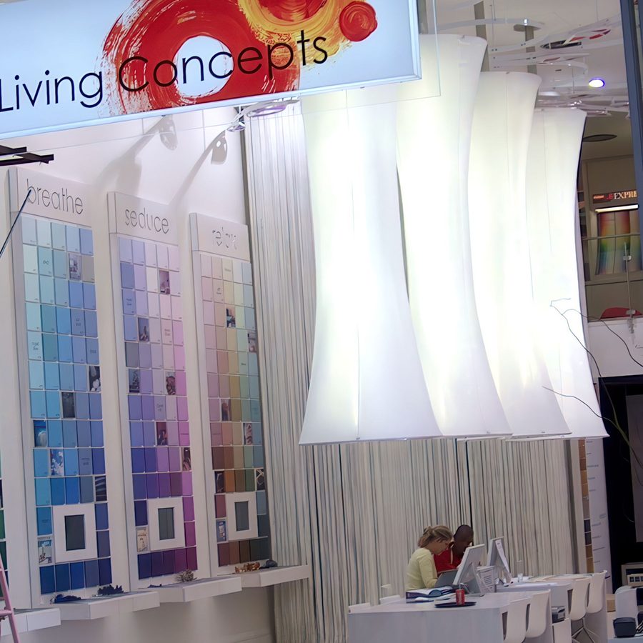 Sculptural white light fittings displayed in a paint showroom